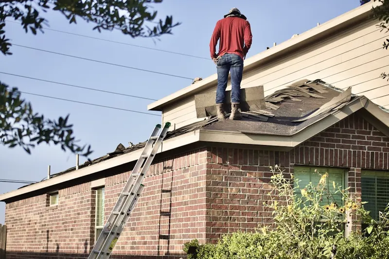 Professional roofer working on a residential roof in Marshall Corner
